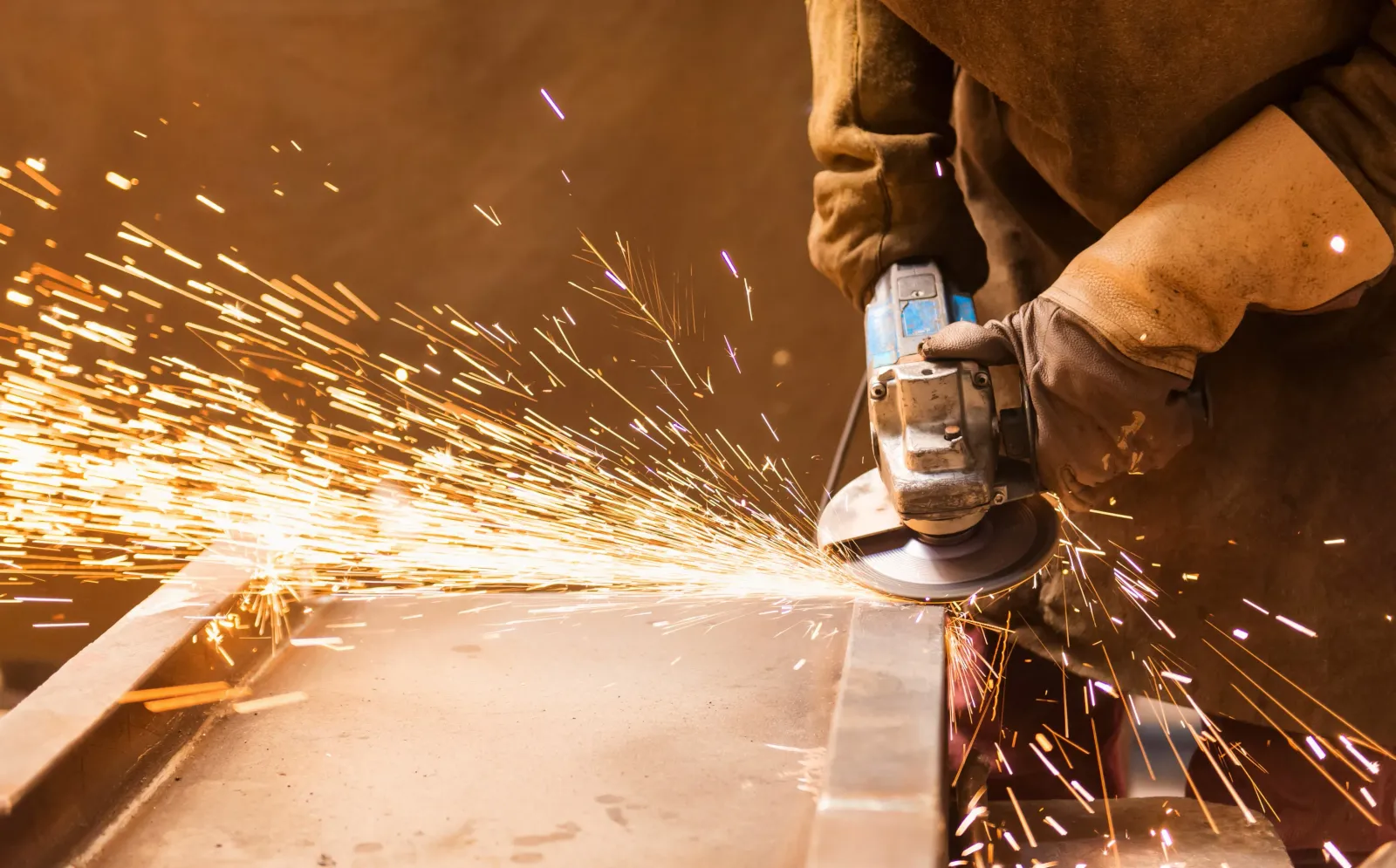 A metal working contractor using an angle grinder.