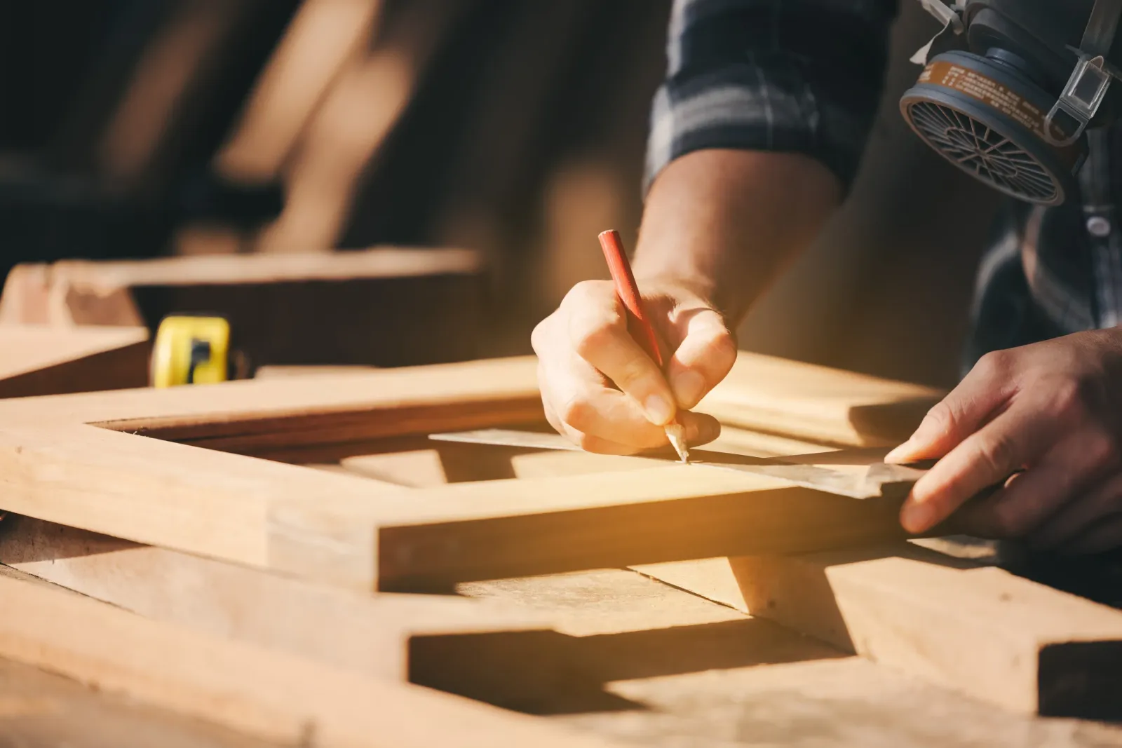 Contractor measuring to cut wood.