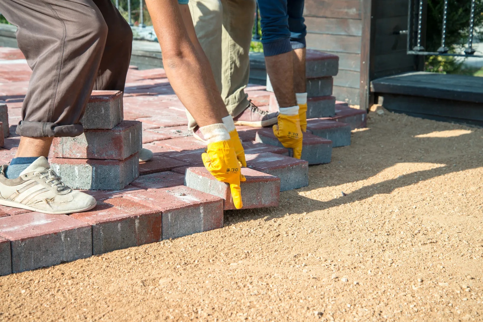 Contractors setting brick tiles