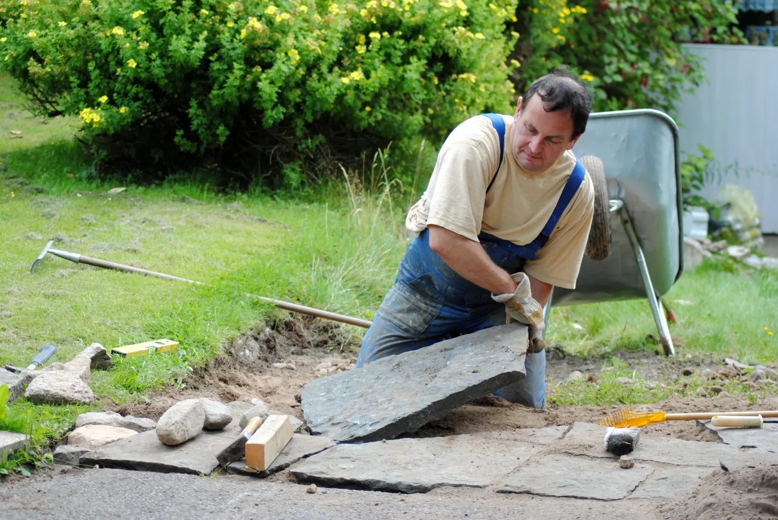 Landscaping contractor works on a stone path