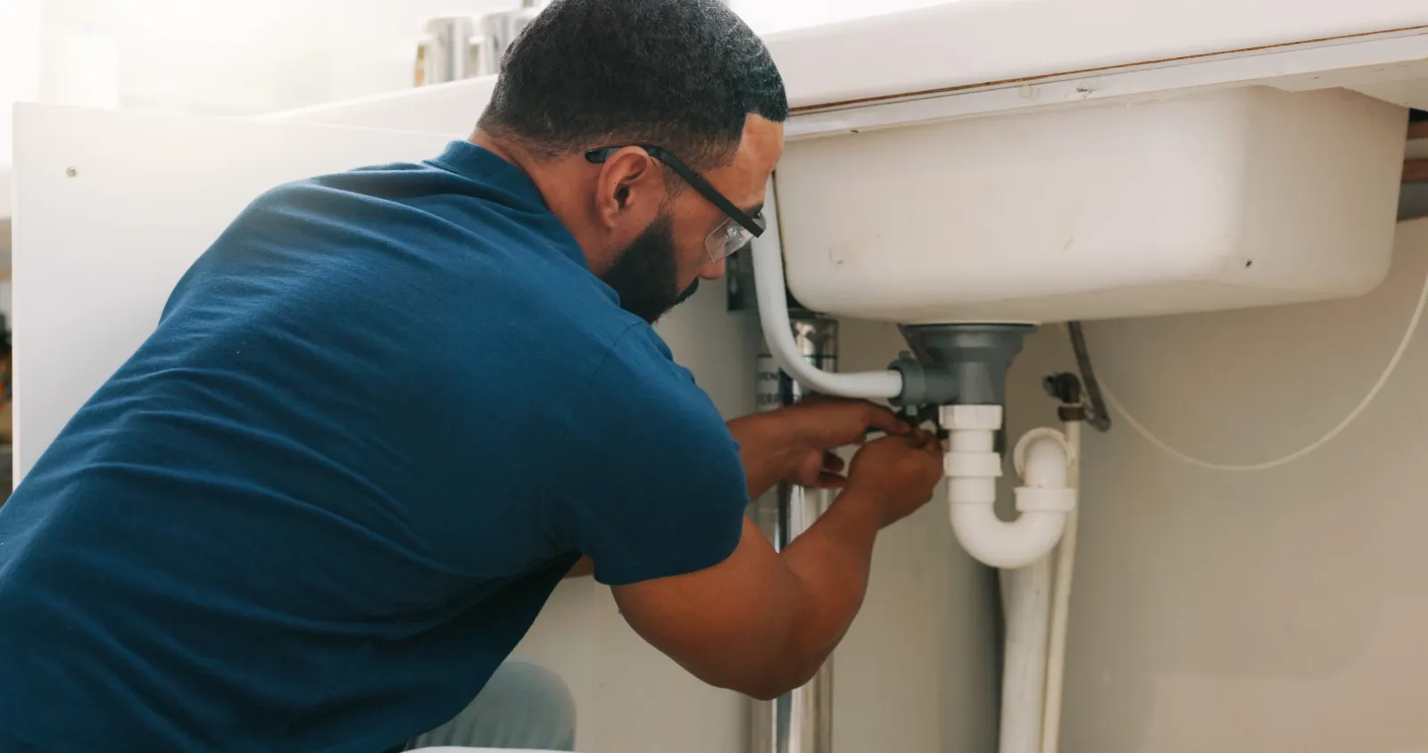 Plumber working on a sink